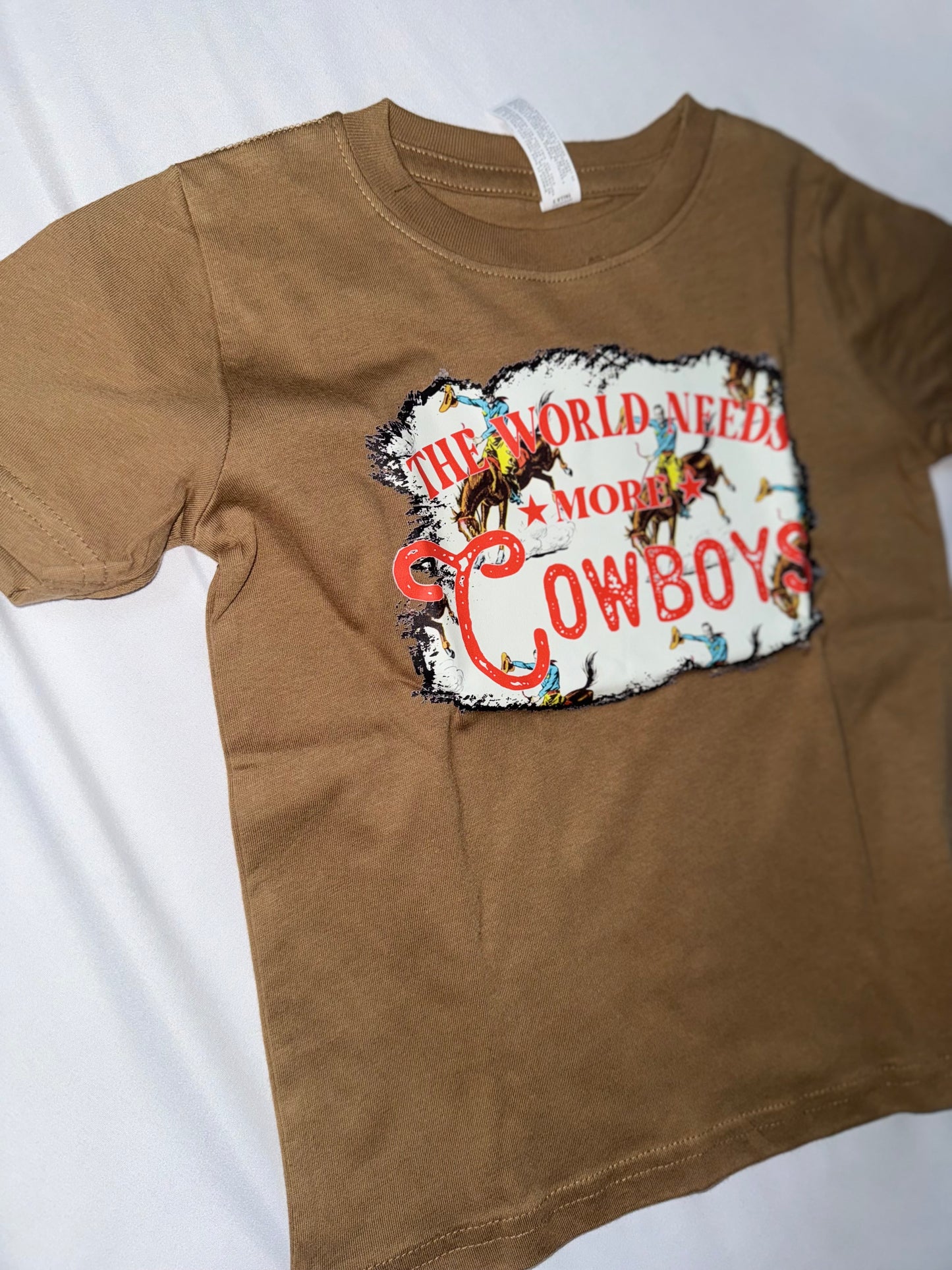 The World Needs More Cowboys Graphic Kids Tee